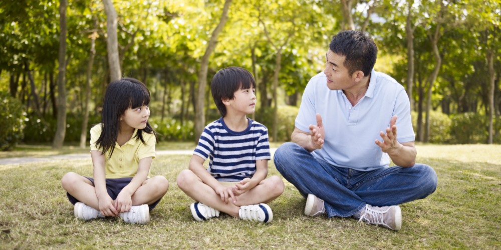 daddy talking with children.