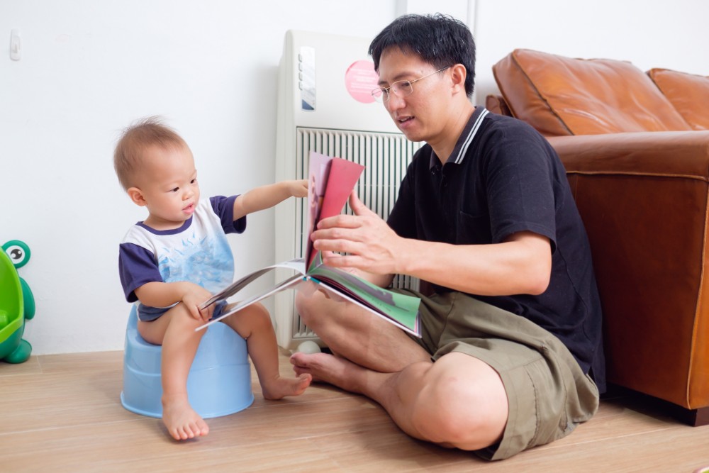 asian dad teaching the baby.