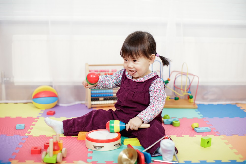 baby playing toys on floor.