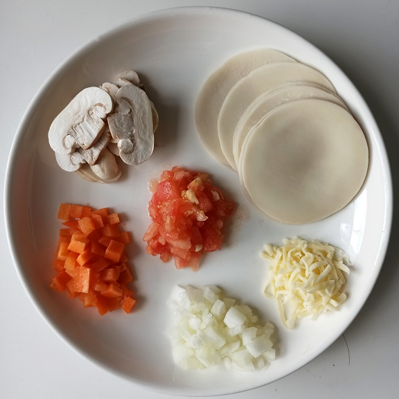 材料有餃子皮、蕃茄、芝士、洋蔥、磨菇